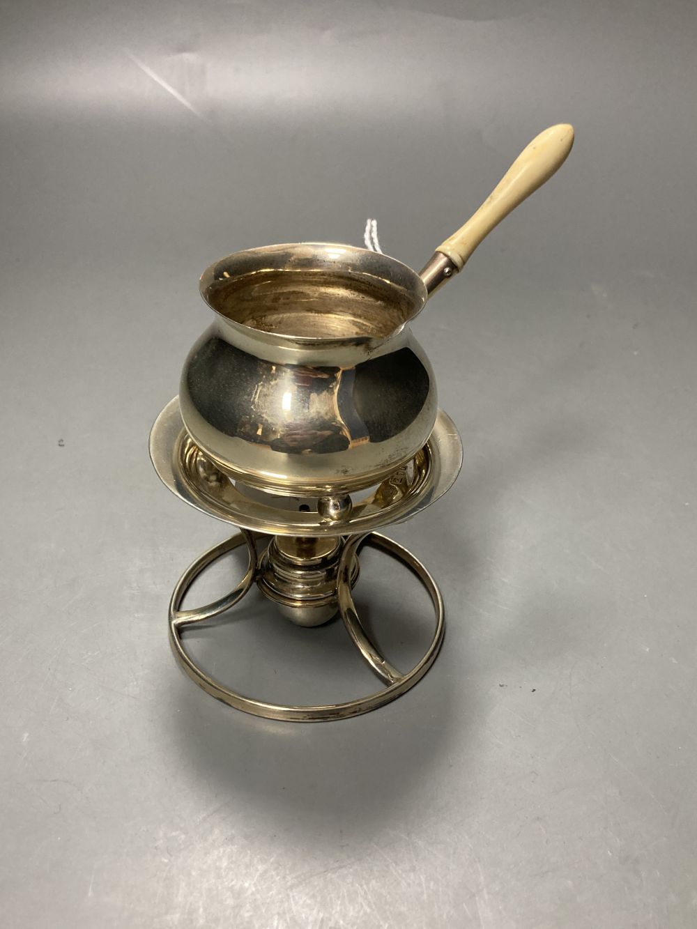 An Edwardian small silver brandy saucepan?, on stand with burner, Carrington & Co, London, 1901,